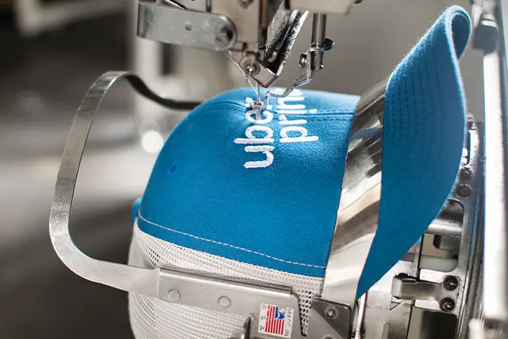 Professional logo embroidery on a cap at Print Your Vibe London